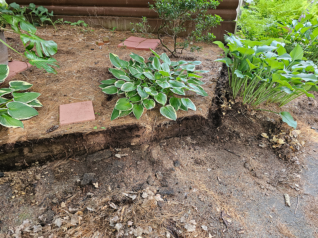 Detailed view of excavation site with removed retaining wall